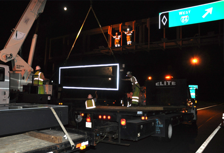 Crane lifting new sign