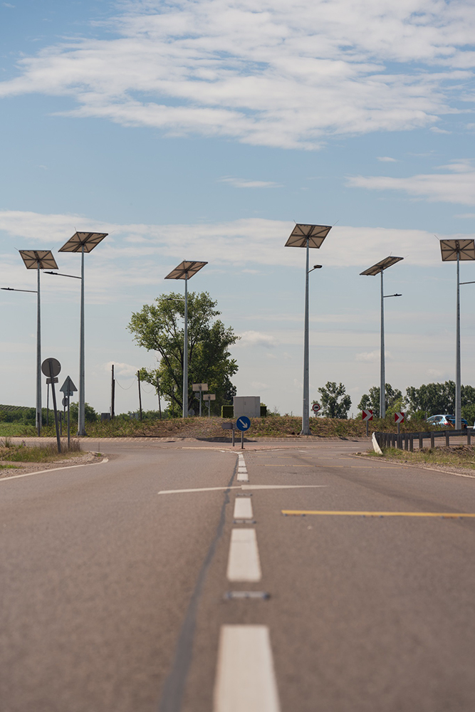 Solar panels sit atop each lamp pole