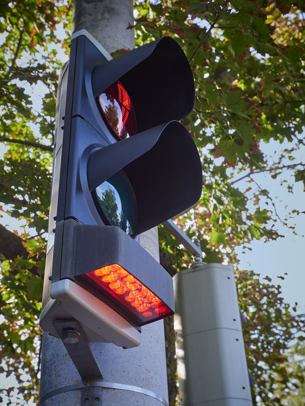 Swarco’s SafeLight shines a red light down to the pavement next to the traffic light pole