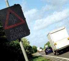 slow down road sign