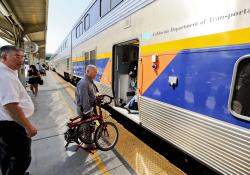 Cyclist boarding Amtrak train Sacramento