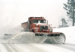 Snow plough clearing snow off the road 