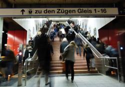 Walking up stairs in train station 