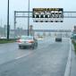 car on road with graphic sign